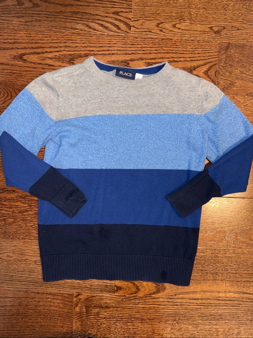 Size medium/7-8 boys blue and gray colorblock stripe crewneck sweater.